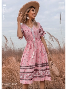 Close-up of pink floral V-neck dress with tassel drawstring and ethnic trim detail