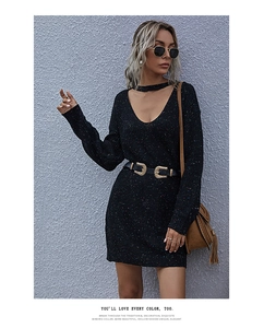 Detail of V-neck knitted dress featuring colorful confetti flecks on soft black fabric