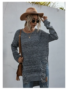 Detail of greyish blue knit sweater featuring stylish frayed hem and distressed hollow out design