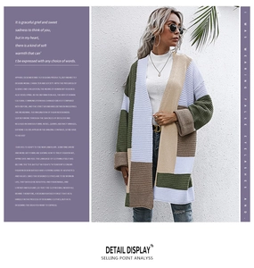 Detail view of color-block knitted cardigan featuring thick texture and geometric patchwork