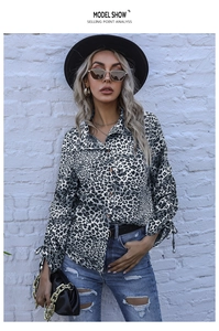 Detail of leopard print shirt featuring lapel collar and drawstring cuffs design
