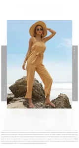Detail of yellow floral jumpsuit featuring delicate ruffle trim and tie-waist at the beach