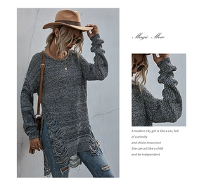 Detail of grey knit sweater showing distressed hollow hem and bohemian fringe style