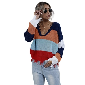 Women's V-neck striped knit sweater with distressed fringe hem and colorful patchwork pattern