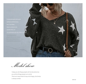 Detail of dark grey V-neck knit sweater featuring oversized white star patterns on the fabric