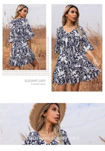 Detail of V-neck floral mini dress with trumpet sleeves and tropical leaf print pattern
