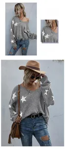 Detail view of V-neck knitted sweater with white star pattern and distressed hem edges