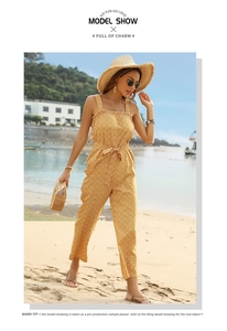 Outdoor shot of a yellow floral strapless jumpsuit with waist tie and ruffled hem