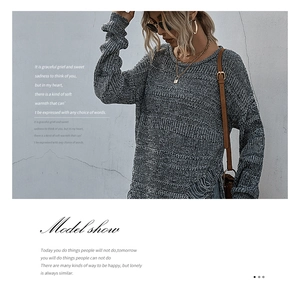 Detail of grey knitted sweater featuring stylish distressed hem and frayed tassels