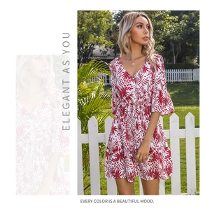 Detail of V-neckline and button decor on a red and white floral bohemian summer dress