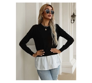 Detail of faux two-piece knit top showing black sweater with white shirt hem and buttons