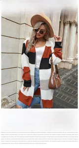 Detail of color block knitted cardigan with black, white, and orange patchwork pattern