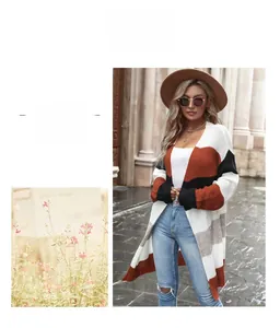 Close-up of color-block patchwork knitted cardigan with cream, orange, and black stripes