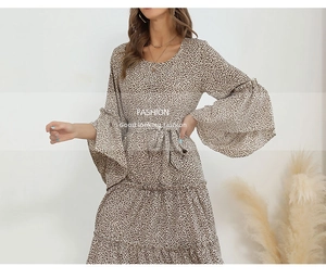 Detail of a leopard print dress featuring large bell sleeves and a tiered skirt design