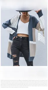 Detail of color-block knit cardigan in blue, white and beige with mid-length open front