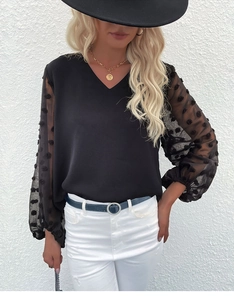 Detail of V-neck top with sheer lantern sleeves featuring textured polka dot patterns