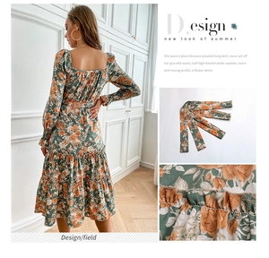 Detail of floral print fabric and ruffled hem on dark green square neck dress