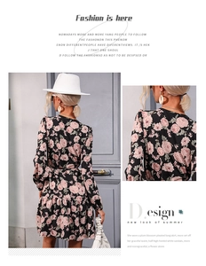 Detail of V-neckline and floral pattern on a black long sleeve dress with waist design