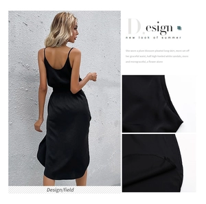 Detail view of smooth silk-like fabric texture and back design of black midi slip dress