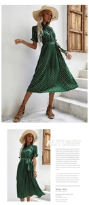 Détail de robe vert foncé à pois avec jupe plissée, ceinture à nouer et manches volantées