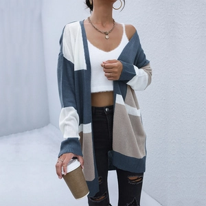 Women's color block long knit cardigan in blue, white, and brown on a casual model