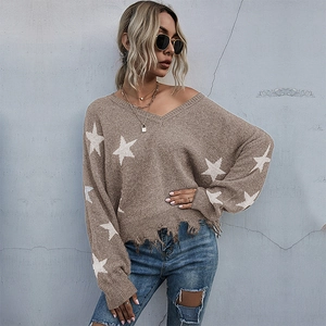 Women's V-neck oversize knit sweater with white stars and distressed fringe hem detail