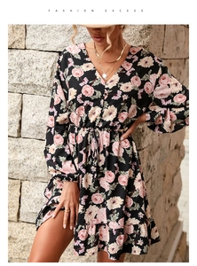 Close-up of V-neck floral dress with pink rose patterns and drawstring waist details
