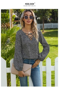 Detail of V-neck leopard print chiffon blouse with lace-up tassels and lantern sleeves