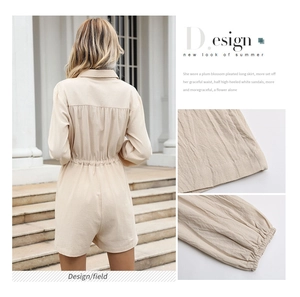 Detail of waist pleats and elastic cuffs on beige cotton linen short romper