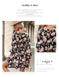 Detail view of the back and ruffled hem of a black floral chiffon long-sleeved dress