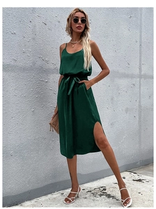 Detailed shot of dark green satin slip dress with waist tie and side slit detail