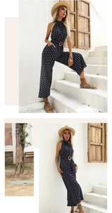 Close-up of polka dot halter jumpsuit featuring a belted waist and wide-leg cut style