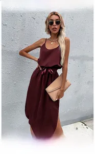 Detail of burgundy satin dress showing the side slit and waist tie belt with chic bow