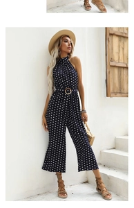 Detailed view of polka dot halter jumpsuit with high waist belt and round buckle feature