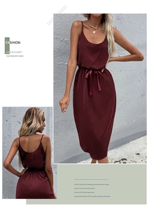 Detailed views of a burgundy midi satin slip dress featuring waist tie and elegant slit