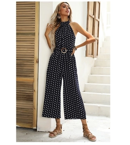 Polka dot halter jumpsuit with wide legs and a matching waist belt featuring a metal ring