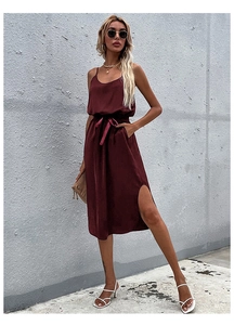 Detail view of burgundy satin midi dress with side slit and waist drawstring tie