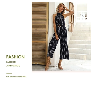 Close-up of black and white polka dot halter jumpsuit with brown belted waist