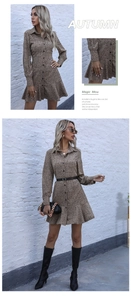 Detail view of leopard print shirt dress with button-up collar and pleated ruffle hem