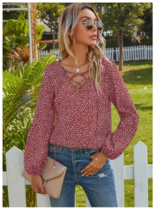 Close-up of leopard print chiffon blouse featuring lace-up V-neck and lantern sleeves