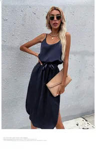 Detailed view of navy blue satin slip dress with adjustable waist tie and side slit