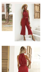 Detail of red polka dot halter neck jumpsuit with a high waist belt and wide leg cut