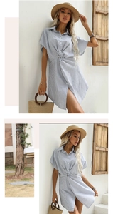 Dettaglio dell'abito camicia a righe blu con nodo in vita e orlo asimmetrico