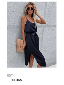 Detail view of navy satin slip dress featuring a side slit and elegant waist tie