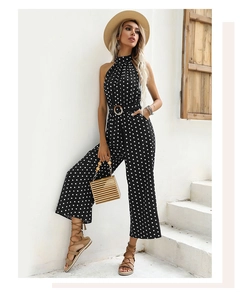 Detail of polka dot halter jumpsuit with high neck and matching belt with round buckle