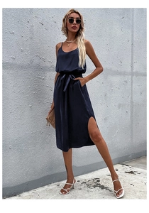Detail of navy blue satin slip dress featuring a waist tie and elegant side slit design