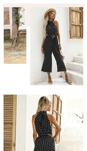 Detail of polka dot halter neck jumpsuit with a round buckle belt and wide leg cut