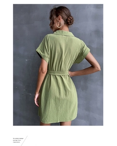 Detail view of sage green cotton-linen shirt dress with classic collar and belted waistline