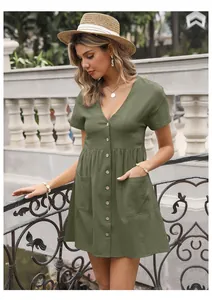 Detail of army green cotton linen dress featuring V-neckline and wood buttons