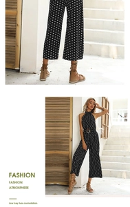 Detailed view of polka dot halter jumpsuit with a wooden buckle belt and wide legs